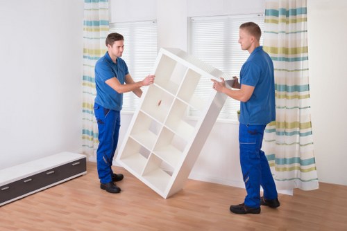Careful moving of furniture through a narrow Hackney staircase